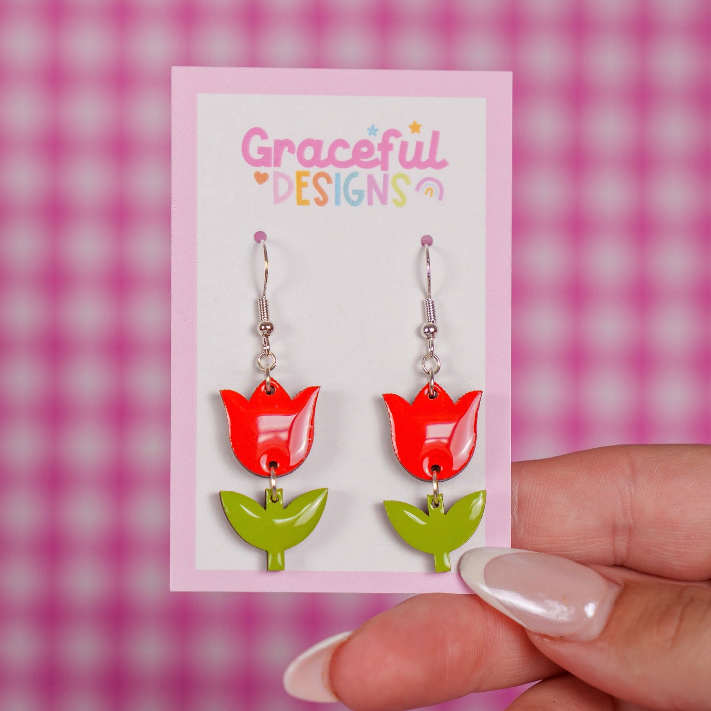 Red tulip-shaped earrings on a 'Graceful Designs' card against a pink checkered background.