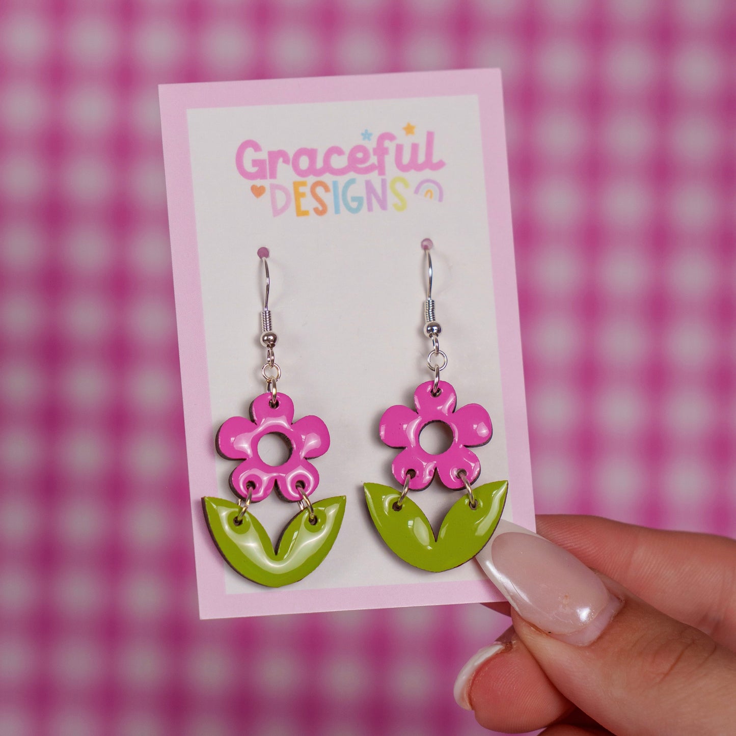 Pink and green floral earrings on a 'Graceful Designs' card against a pink checkered background.