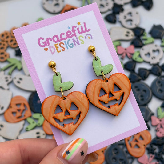 Halloween-themed earrings on a 'Graceful Designs' card with decorative background
