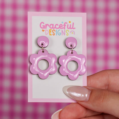 Pink floral earrings on a 'Graceful Designs' card against a pink checkered background