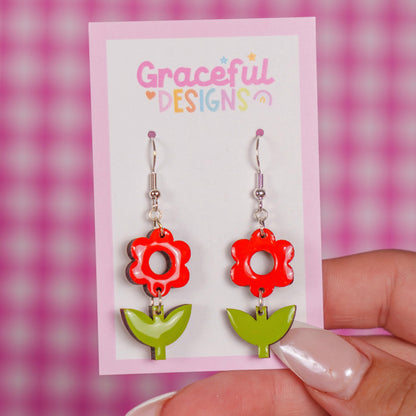 Red and green floral earrings on a 'Graceful Designs' card against a pink checkered background.
